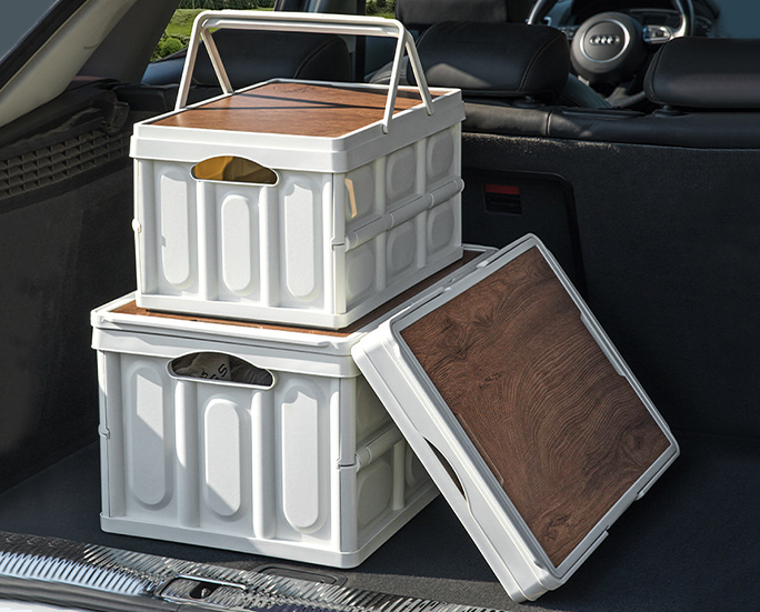 Person carrying a white folding storage crate with wooden top