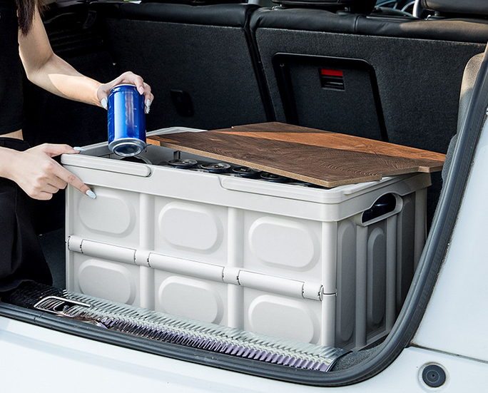 Foldable storage box with wooden lid placed in vehicle trunk