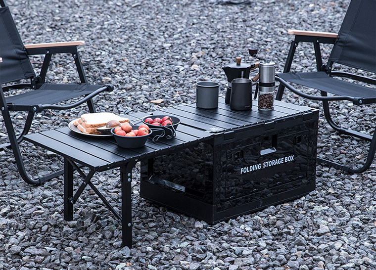 Camping setup using folding storage box table with food and coffee equipment