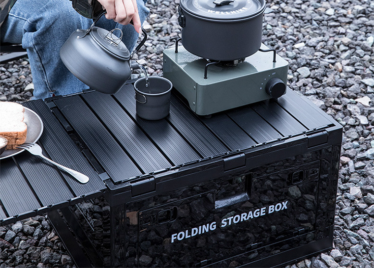 Outdoor breakfast scene with folding box table and food setup