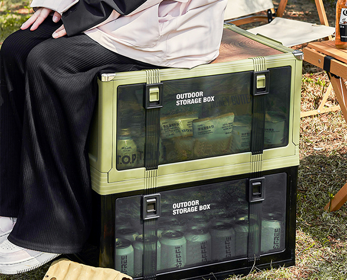 Person sitting on stacked outdoor boxes used as seating.