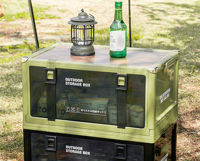 Outdoor storage boxes with lantern and bottle placed on top.