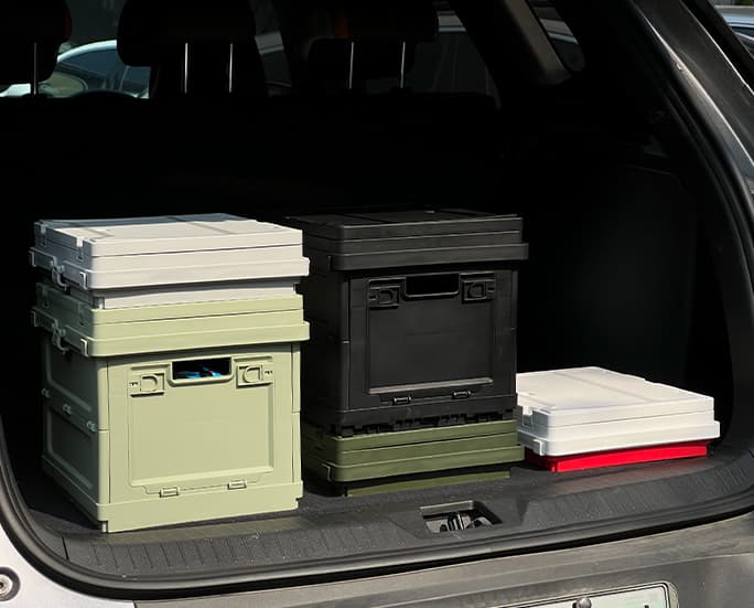 Stacked collapsible storage boxes in a car trunk