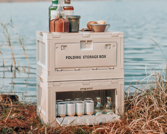 Camping lady accessing food inside folding box cabinet