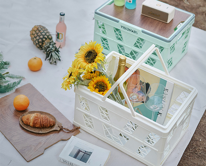 Stackable folding crates in mint green, black, and white with handles