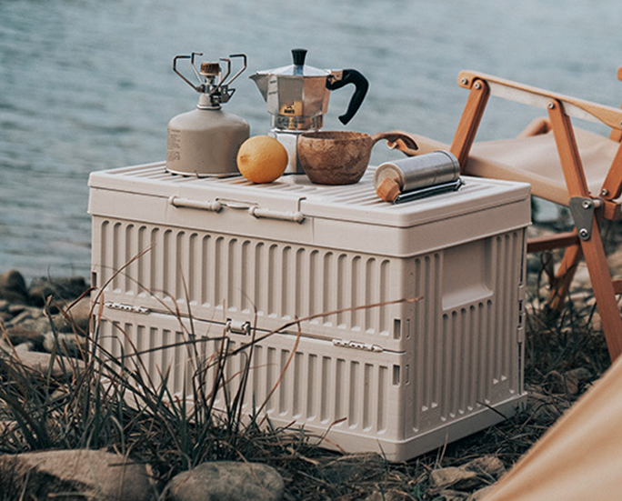 Cream white camping folding box used as a table for coffee setup