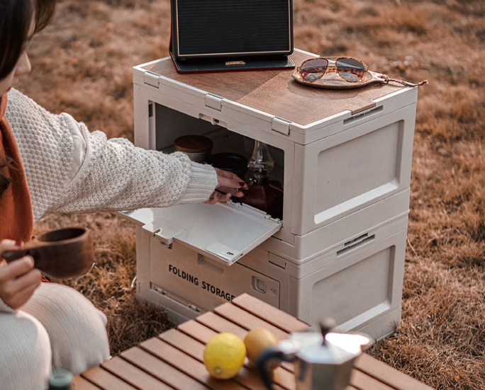 White folding box serving as lakeside drink table