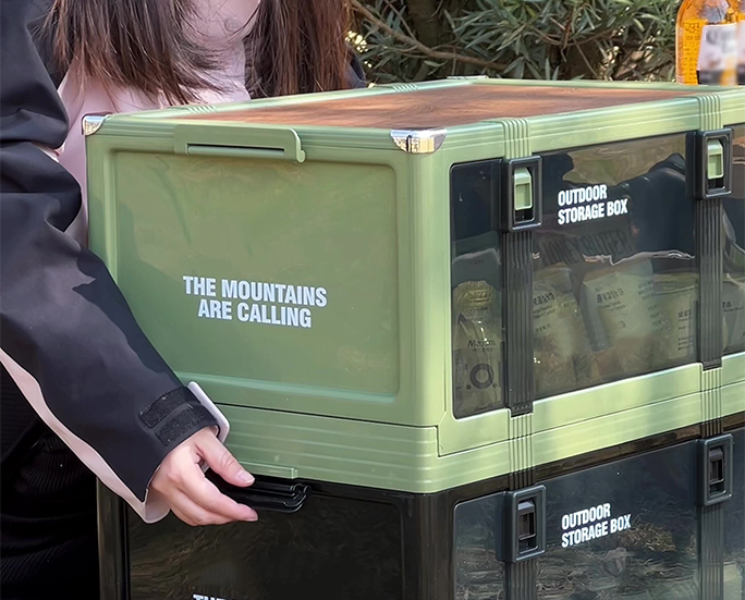Green storage box with slogan “The Mountains Are Calling.”