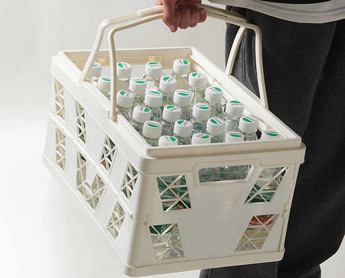 Sunlit white picnic crate with sunflower on blanket