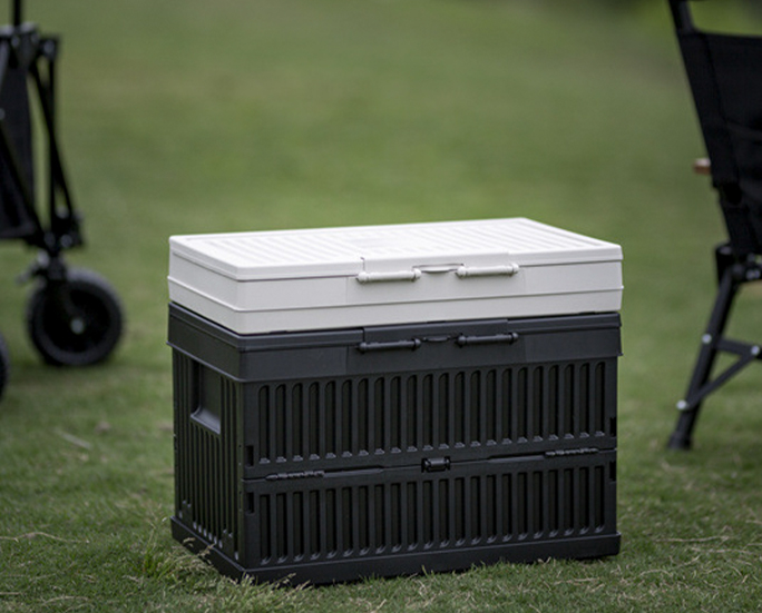 Fully assembled black storage box with folded white box stacked on top