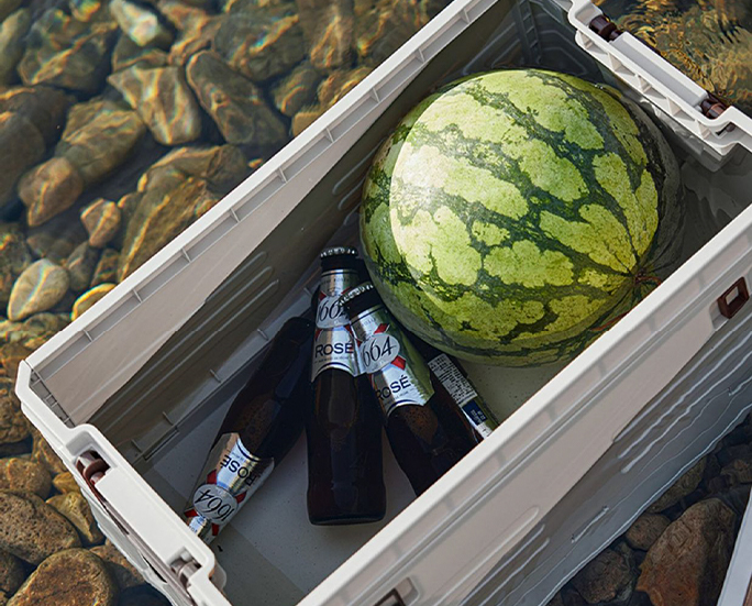 Watermelon and beer stored in waterproof folding crate