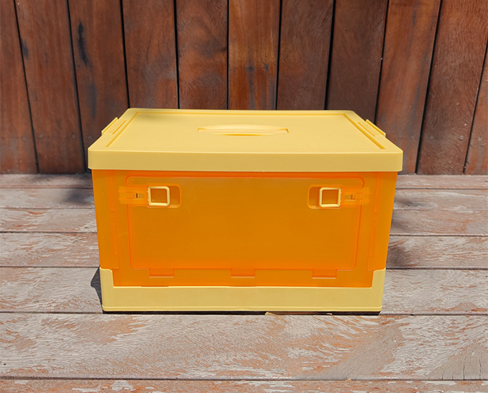 Front view of yellow plastic folding crate with locked front door