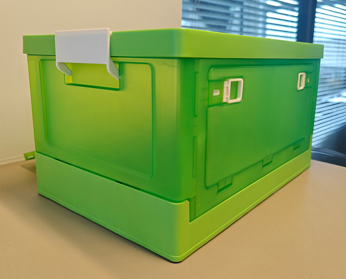 Green foldable storage crate with reinforced corners and side locks