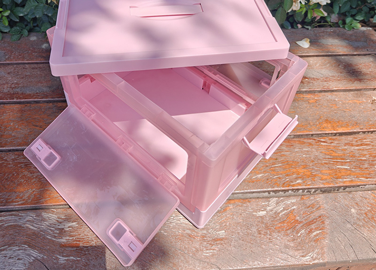 Top-down view of pink storage box with side latch and open front