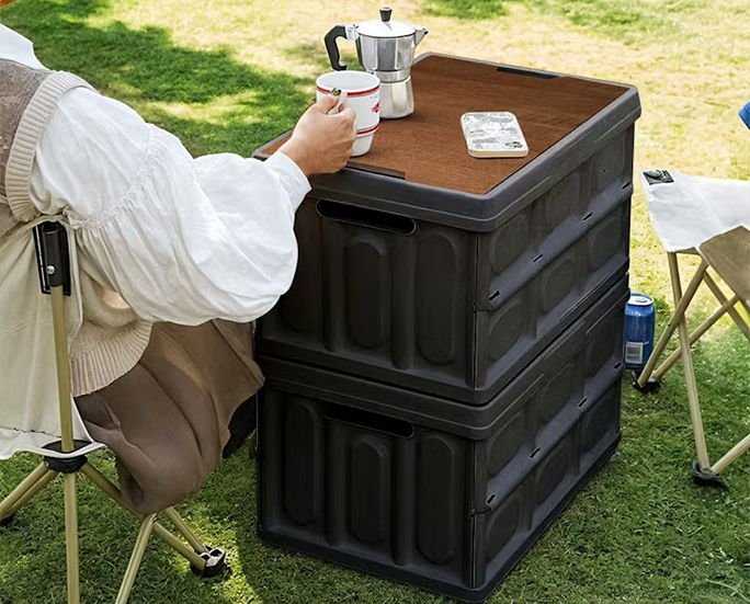 Foldable camping storage box used as outdoor side table